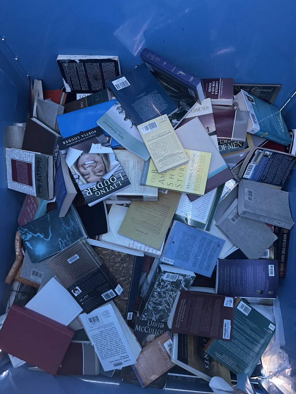 Looking down into a donation bin filled to the top with donated hardcovers and paperbacks in Albuquerque
