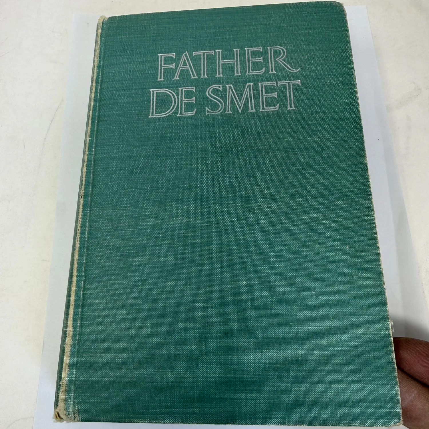 Cover of Father De Smet by Helene Magaret — green cloth binding with silver lettering, Farrar and Rinehart 1940 first edition, no dust jacket. Biography of Jesuit missionary Pierre-Jean De Smet. Photographed at the New Mexico Literacy Project in Albuquerque.