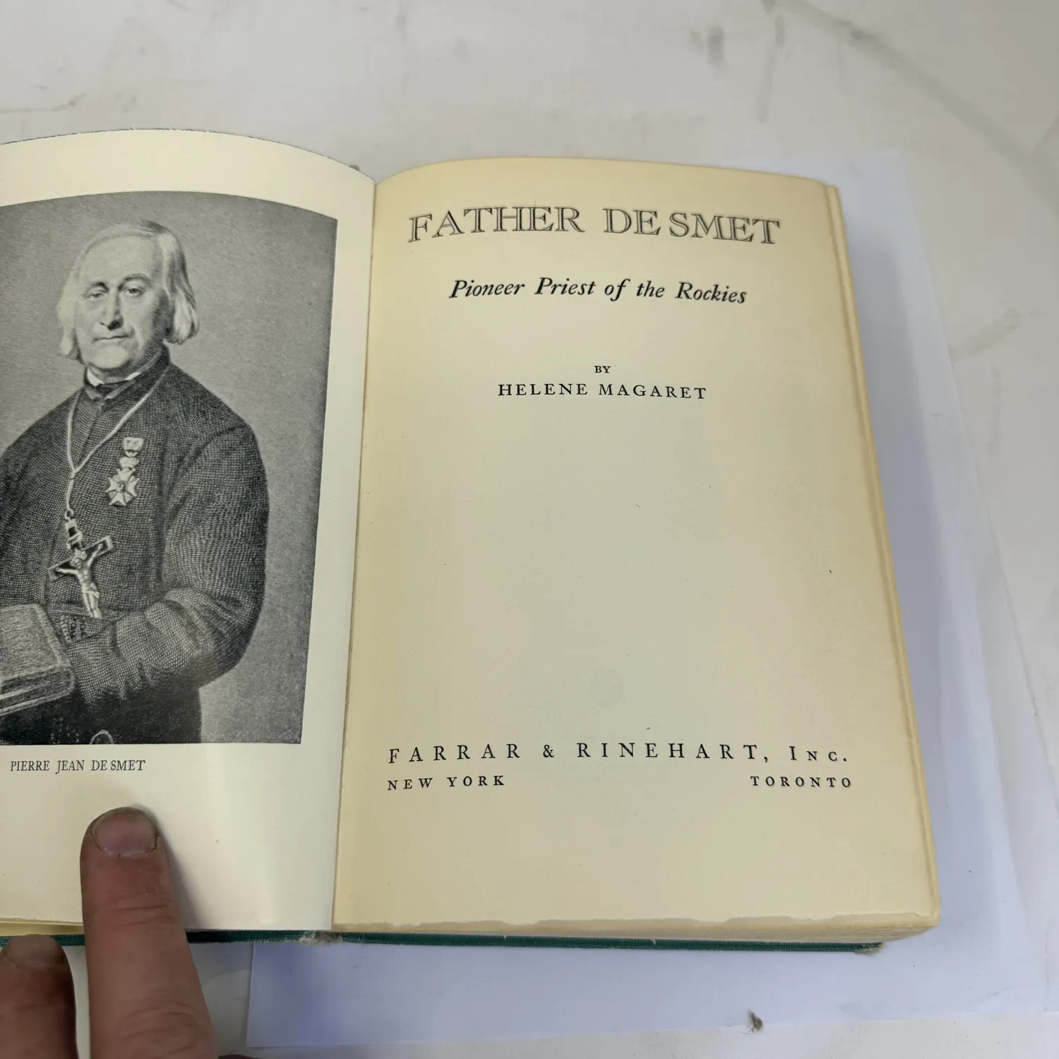 Title page and frontispiece of Father De Smet Pioneer Priest of the Rockies by Helene Magaret, Farrar and Rinehart Inc New York and Toronto 1940. Frontispiece shows an engraved portrait of Pierre Jean De Smet wearing medals and clerical dress, holding a book.