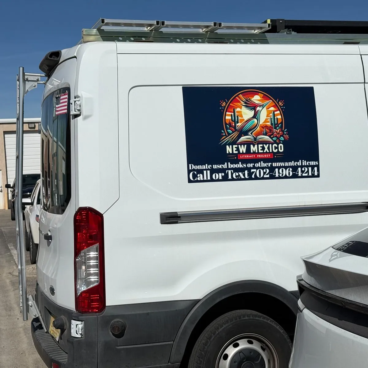 New Mexico Literacy Project free book pickup van in Albuquerque — white Ford Transit serving estates, classrooms, and moves across the metro area