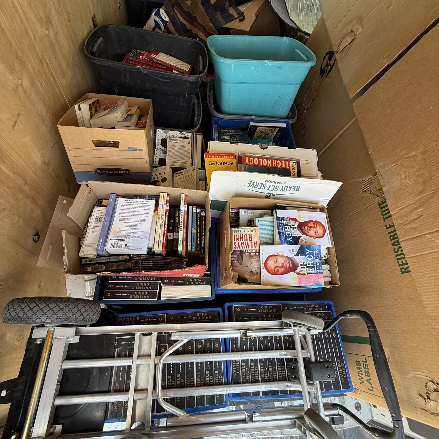 The NMLP van loaded with boxes and totes of donated classroom books and class sets — Invisible Child, Just Mercy, Always Running — from Gilbert L. Sena Charter High School in Albuquerque
