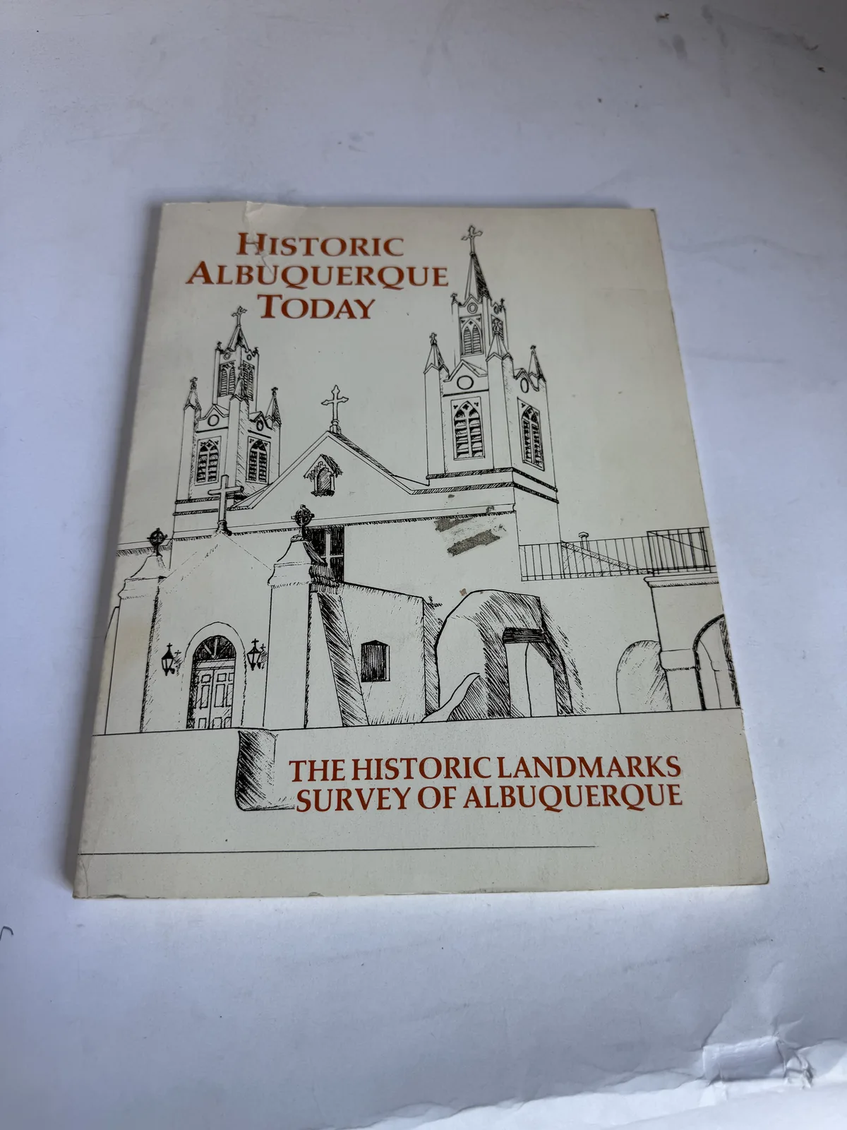 Cover of Historic Albuquerque Today, an overview survey of historic buildings and districts, with a drawing of San Felipe de Neri church, photographed at New Mexico Literacy Project