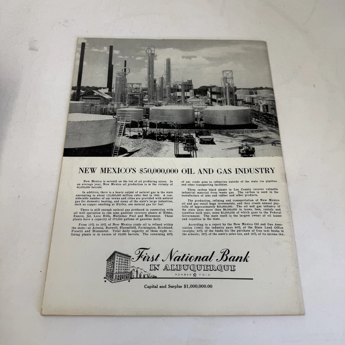 Back cover of a vintage New Mexico Magazine: First National Bank in Albuquerque advertisement with a photograph of oil refinery works, promoting the state oil and gas industry — photographed at New Mexico Literacy Project