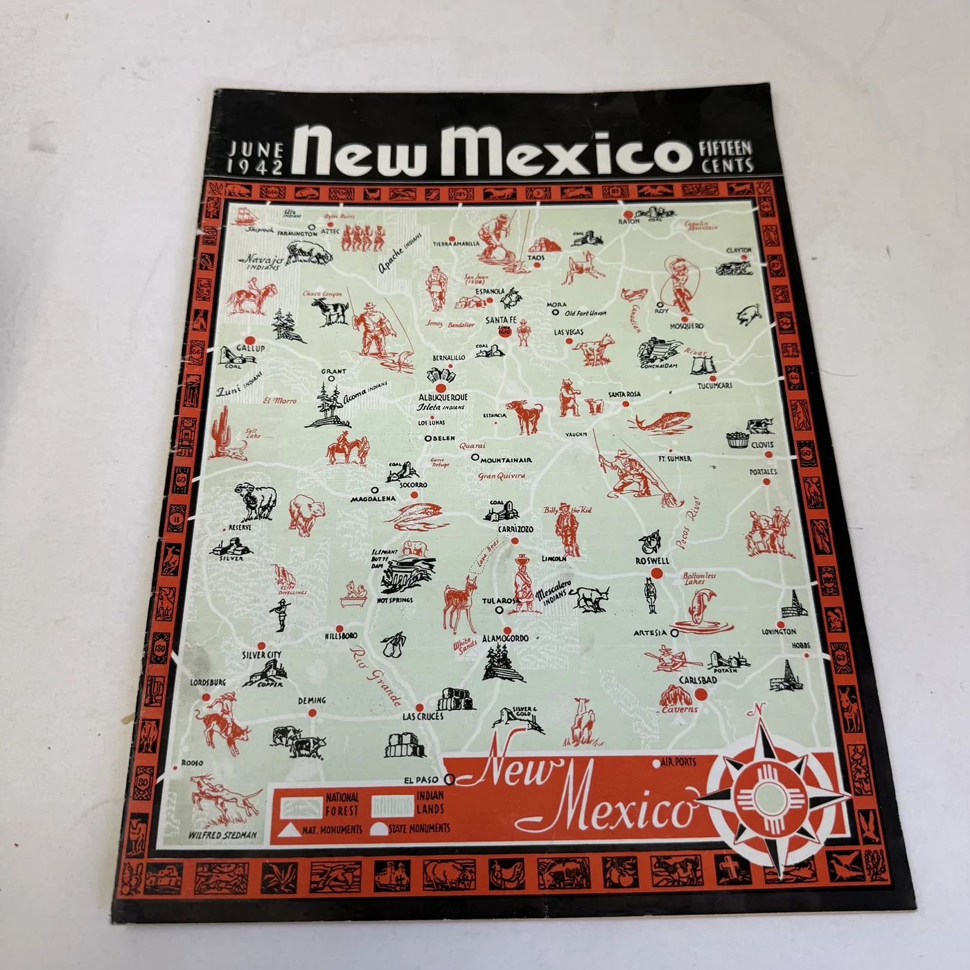 June 1942 New Mexico Magazine cover: Wilfred Stedman pictorial state map with woodcut-style vignette border, signed in the plate — photographed at New Mexico Literacy Project
