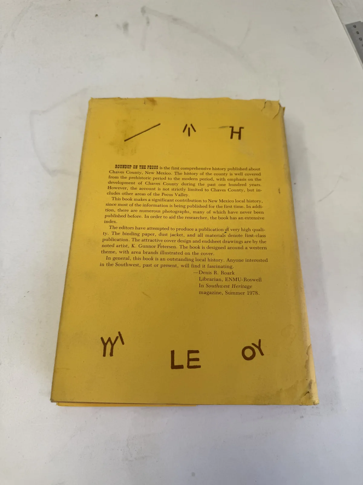Back cover of Roundup on the Pecos carrying a 1978 Southwest Heritage review by Denis R. Roark of ENMU-Roswell, surrounded by more cattle brands, photographed at New Mexico Literacy Project