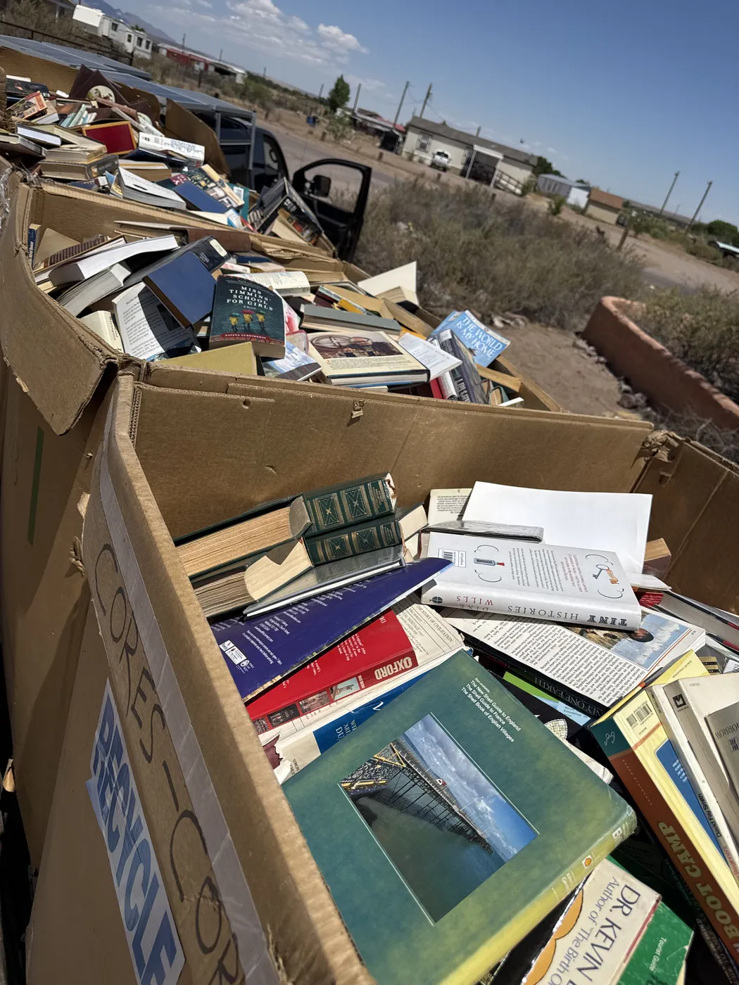 Truck bed loaded with books from the May 9 2026 Socorro pickup, en route back to Albuquerque on I-25