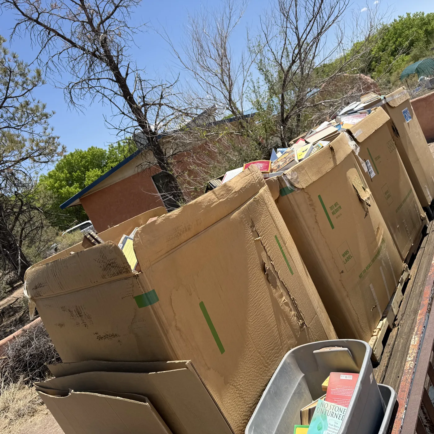Wall of stacked banker boxes from a Socorro County estate book pickup — 5,000 pounds moved in three hours