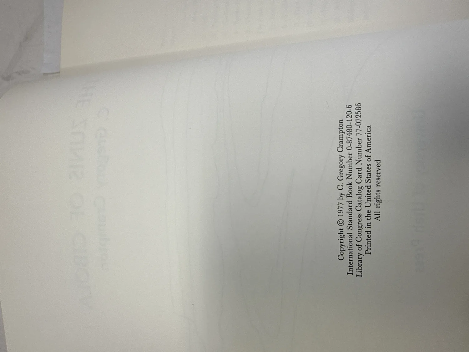 Copyright page of The Zunis of Cibola showing Copyright 1977 by C. Gregory Crampton, ISBN 0-87480-120-6, Library of Congress Catalog Card Number 77-072586. Photographed at the New Mexico Literacy Project sorting desk in Albuquerque.
